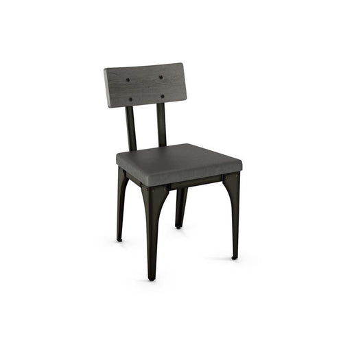 Modern industrial dining chair with upholstered seat, steel frame, and wood backrest